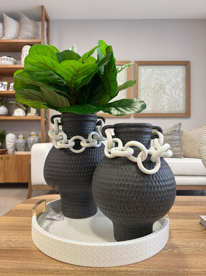 Detalle de bandeja redonda blanca con asas doradas, base de madera revestida en polipiel para decoración